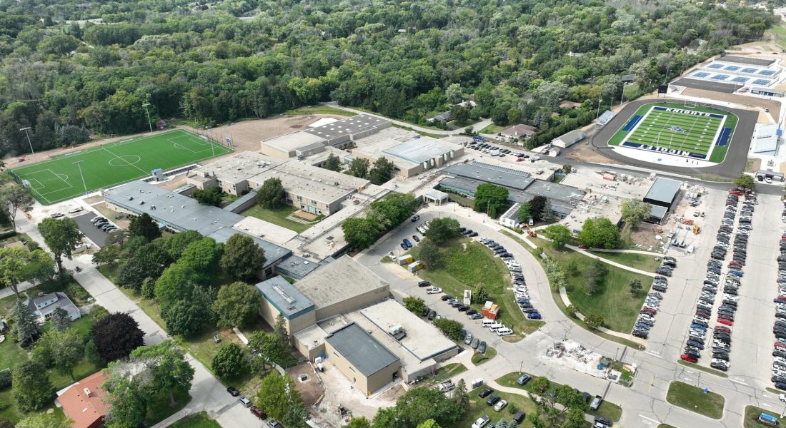 Aerial view of school campus with buildings and sports fields.
