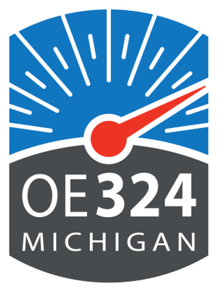 Badge logo with red needle, blue rays, OE324 Michigan.